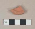 Unglazed redware vessel base fragment, possibly flowerpot