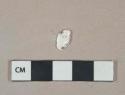 White shell fragment, heavily degraded