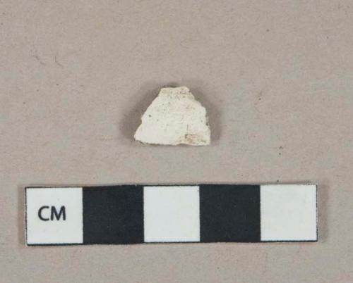 White undecorated kaolin pipe bowl fragment, burned interior