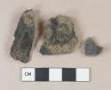 Stone fragments with asphault or tar, 1 burned coal fragment
