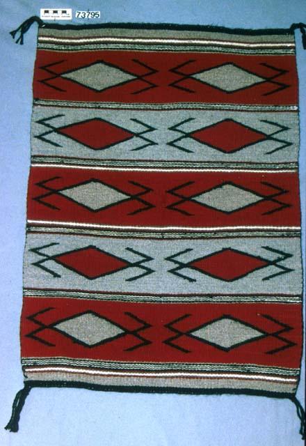 Banded rug with red and gray "water bugs"