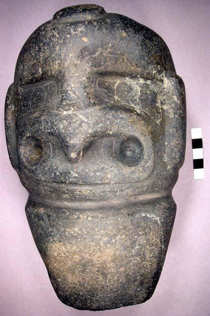 Stone axe in form of head