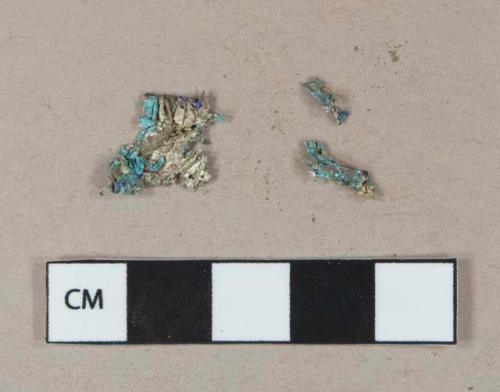 Silver and blue-colored metal foil wrapper fragments