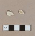 White mortar fragments, heavily degraded