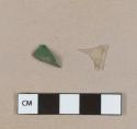 Plastic fragments, 1 colorless clear fragment, 1 green fragment