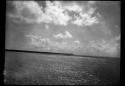 Water, with shoreline and lighthouse in distance