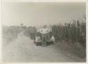 Man in front of automobile on side of road