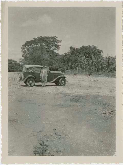 Woman standing in front of automobile
