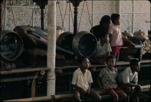 Boys sitting next to old gamelan, Grebeg festival