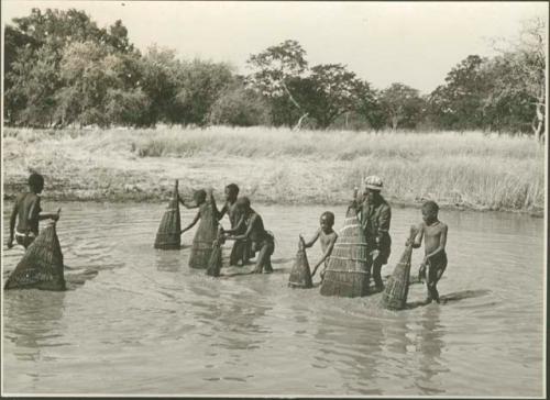 People fishing with baskets (print is a cropped image)