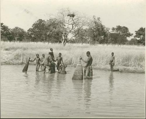 People fishing with baskets