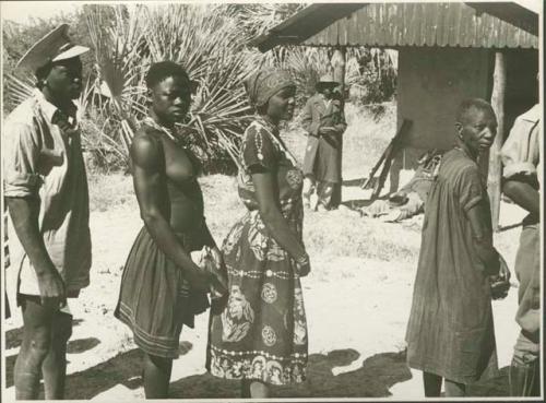 People standing in a line (print is a cropped image)