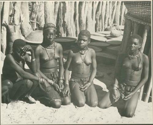 Four women kneeling (print is a cropped image)