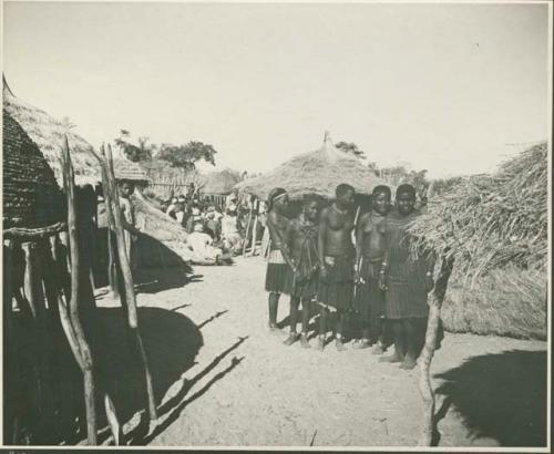 Group of women standing inside kraal (print is a cropped image)