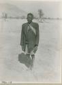 Man wearing a sash of office, standing