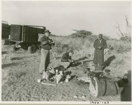 John Marshall, Edward Hartley and Laurence Marshall eating in the expedition camp