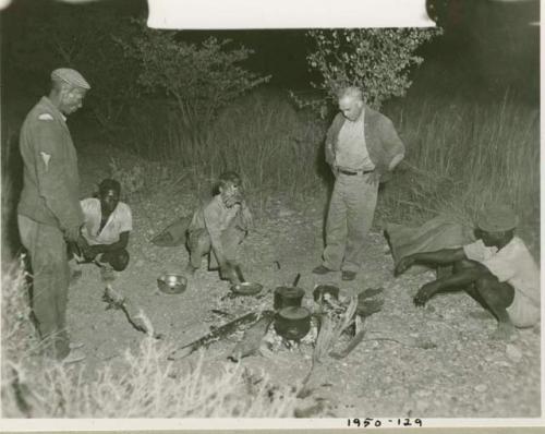 Edward Hartley, John Marshall, Laurence Marshall and two other expedition members in camp at night