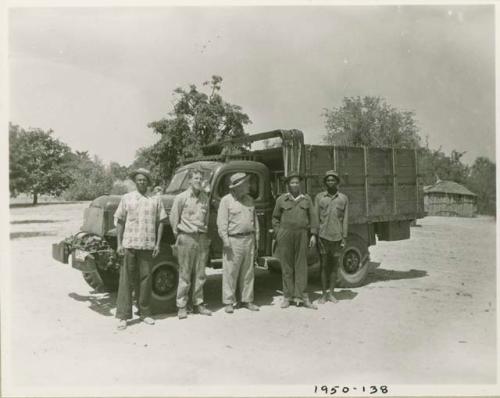 John Marshall, Laurence Marshall and three other expedition members standing in front of a truck