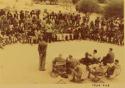 Indaba at Omajetti, Herero chief, with a large group of people sitting and standing behind him, addressing expedition members, including Colonel Hoogenhout, John Neser, Laurence Marshall and John Marshall