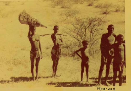 People standing and holding fishing gear