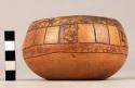 Small pottery bowl - black, yellow, red painted incised design