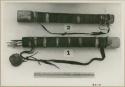 Two quivers; one with arrows inside, one with its cap on, and a ruler for measurement