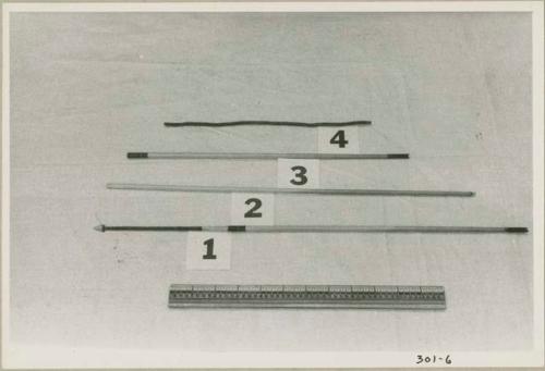 One complete arrow, two arrow shafts, one fire-stick, and a ruler for measurement