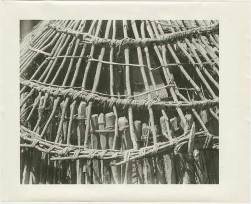 Framework of partly finished hut, close-up (print is a cropped image)