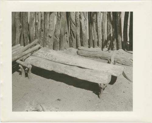 Bench in room where guests are received (print is a cropped image)