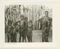 Woman standing with a group of children (print is a cropped image)