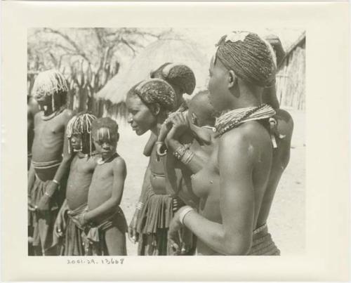 Women and children standing in a semi-circle, close-up (print is a cropped image)