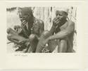 Three men sitting and taking snuff (print is a cropped image)