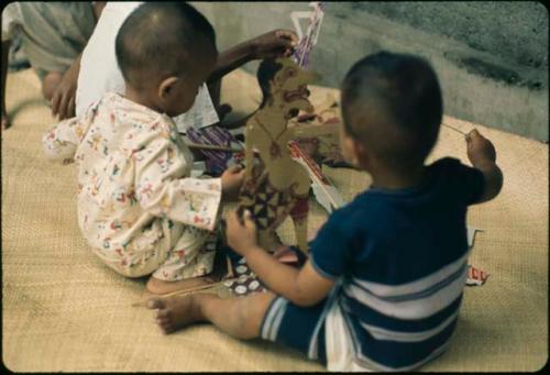 Child playing with paper puppets