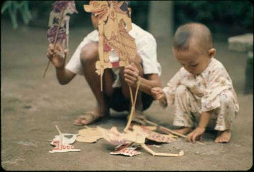 Children playing with paper puppets