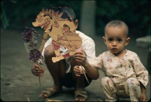 Children playing with paper puppets