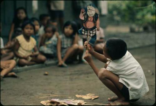 Children playing with paper puppets