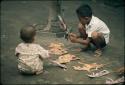 Children playing with paper wayang puppets