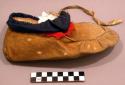 Moosehide moccasin with red & blue cloth on top