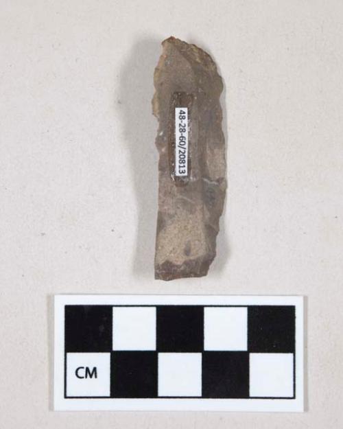 Chipped stone, flint blade, possibly serrated