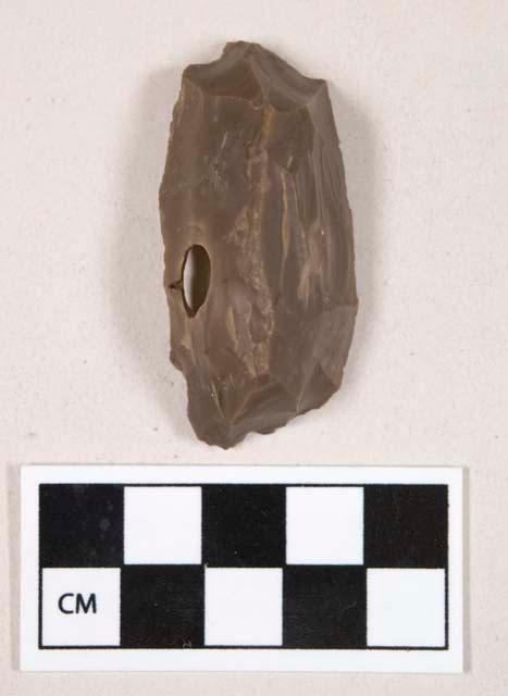 Chipped stone, flint scraper, with likely natural hole through it