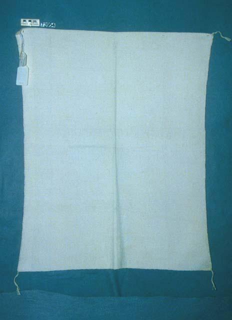 White cotton manta, undecorated, tassel in each corner