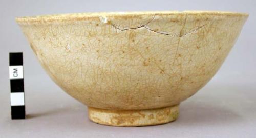 White ware bowl - ring base; greenish brown glaze; dots of clay in bottom