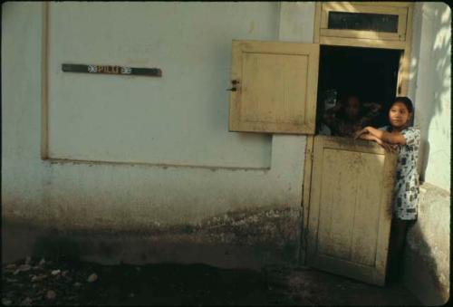 Woman standing next to door