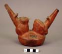 Red pottery vessel, frog and cat ornament, with 2 spouts and stirrup handle