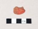 Unglazed, red painted, molded redware body sherd