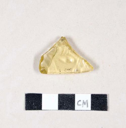 Molded yellow bottle glass fragment