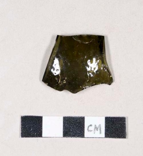 Olive green bottle glass fragment, with textured surface and mold seam