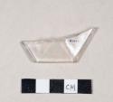 Faceted colorless glass fragment, possible stemware base fragment