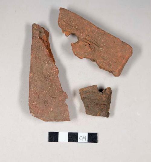 Redware roof tile fragments, some with nail holes