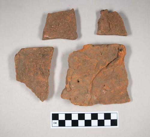 Redware roof tile fragments, one with nail hole